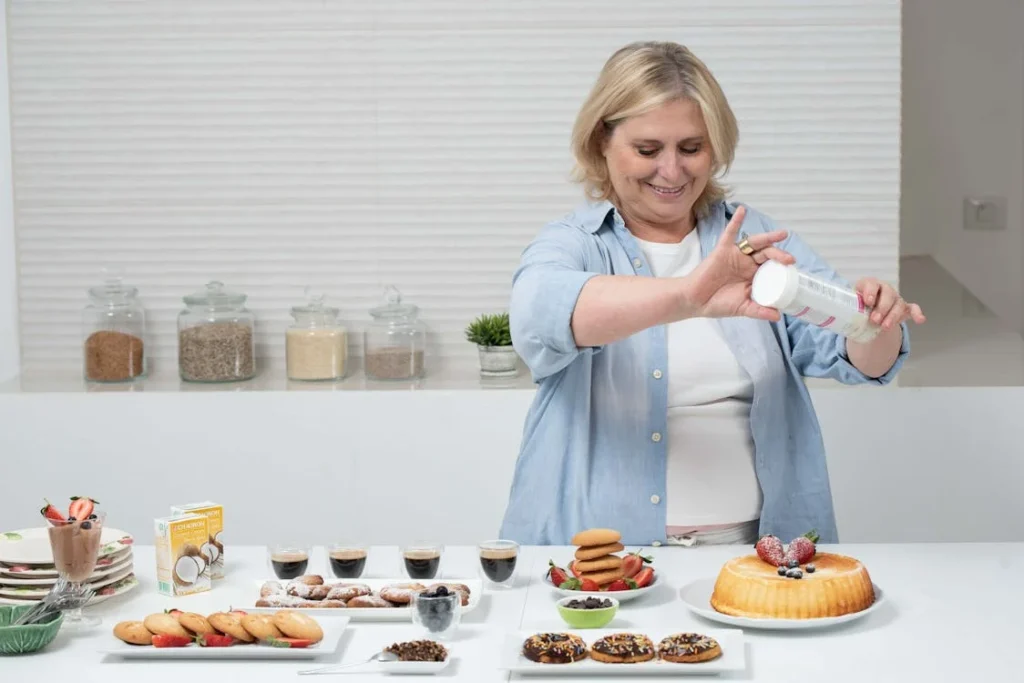 alt="Amanda standing in the kitchen smiling – recipe author at Beam Recipes"