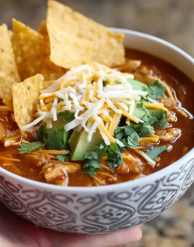 Chicken white bean chili Instant Pot topped with cheese and chips