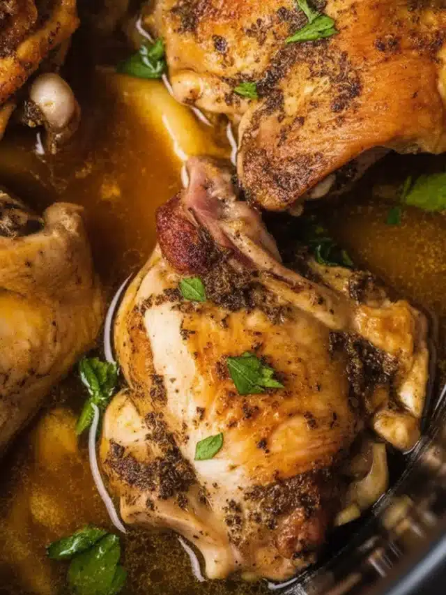 Tender bone-in chicken thighs cooked in a crockpot with garlic and herbs.