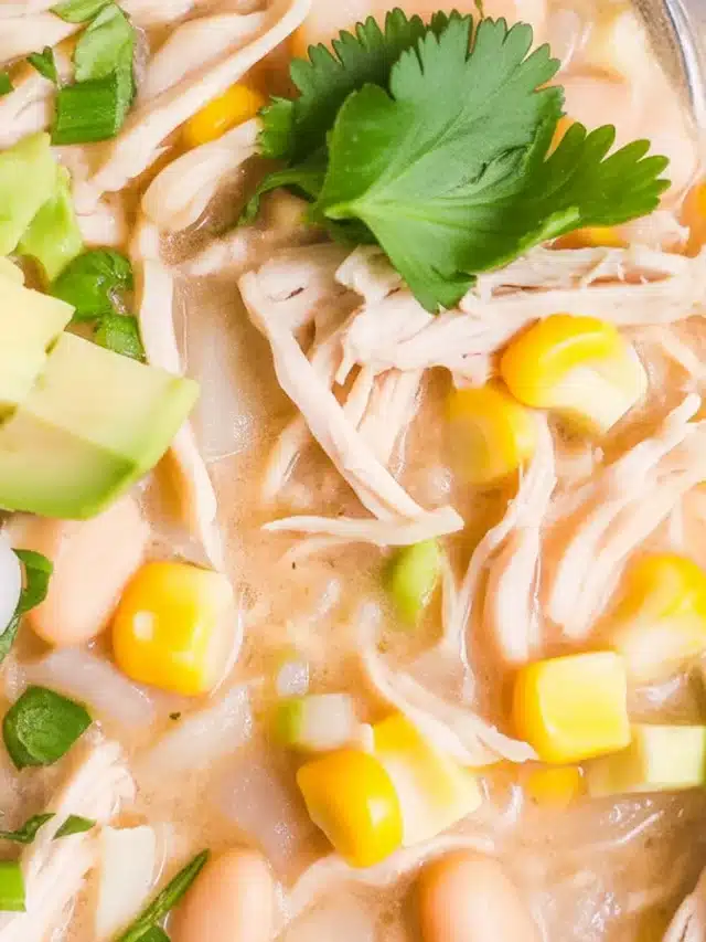 Delicious Instant Pot White Chicken Chili topped with green onions and served in a bowl.