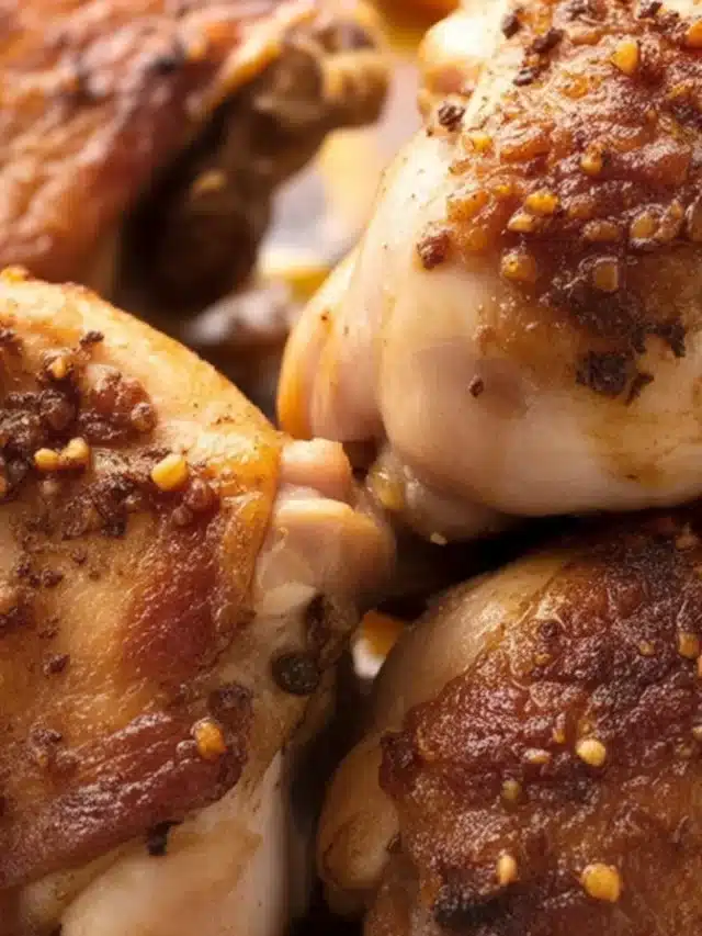 Crispy and juicy baked chicken thighs garnished with herbs