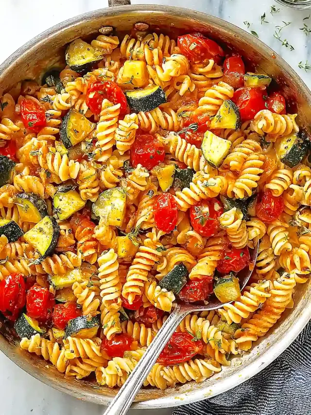 A delicious bowl of Zucchini Butter Pasta topped with fresh herbs and cheese.