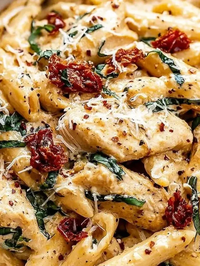 Creamy Marry Me Chicken Pasta garnished with fresh basil on a white plate.