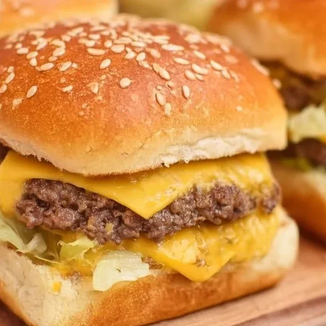 Mini Big Mac Sliders served on a platter with pickles and cheese