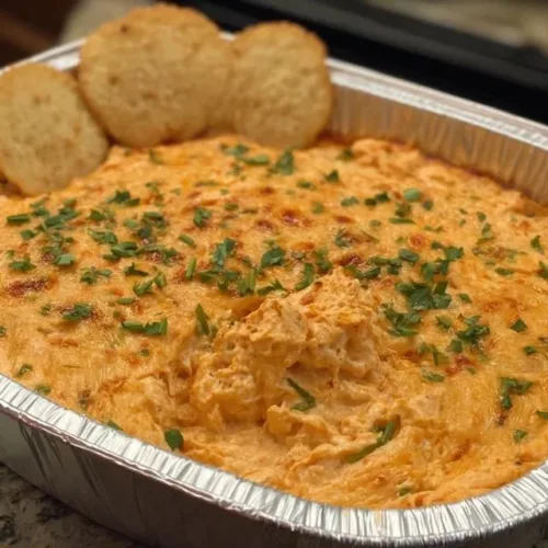 A creamy and spicy Buffalo Chicken Dip served in a bowl with tortilla chips.