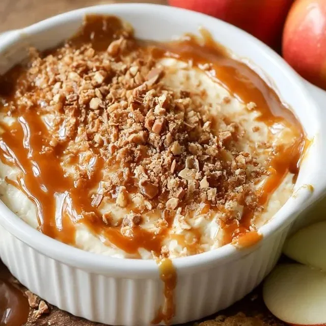 Cream cheese caramel apple dip topped with toffee bits served in a bowl