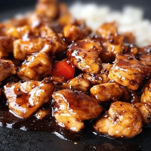Delicious Blackstone Bourbon Chicken with a sweet and savory glaze on the grill.