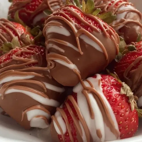 Delicious chocolate covered strawberries on a platter, perfect for celebrations.