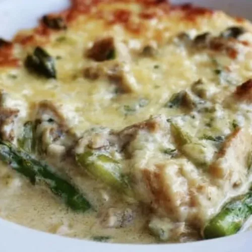 Creamy asparagus chicken casserole topped with breadcrumbs and cheese