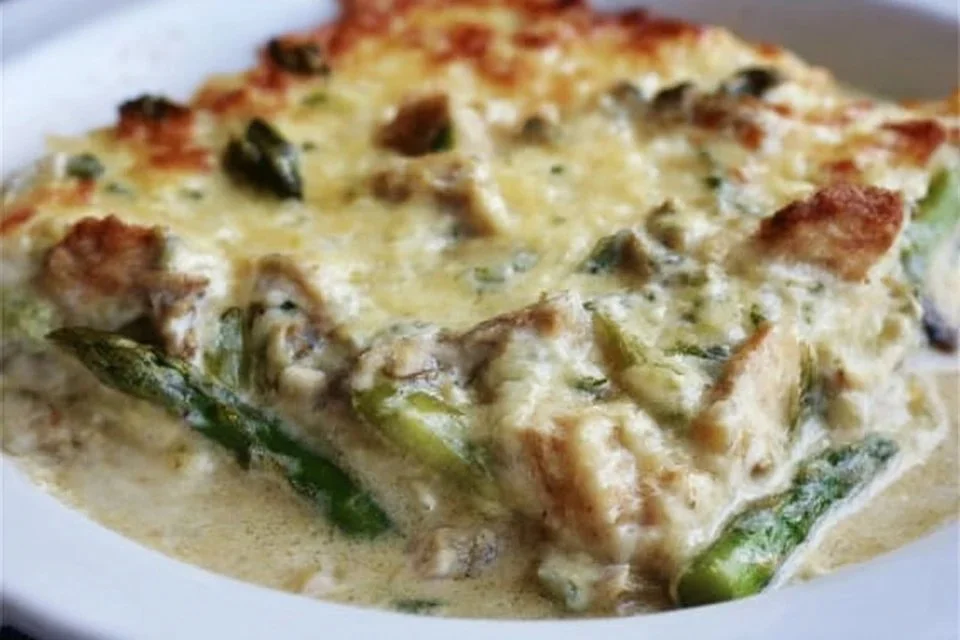 Creamy asparagus chicken casserole topped with breadcrumbs and cheese