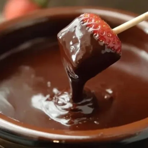 Rich and creamy chocolate fondue made in a crock pot, served with fruits and treats.
