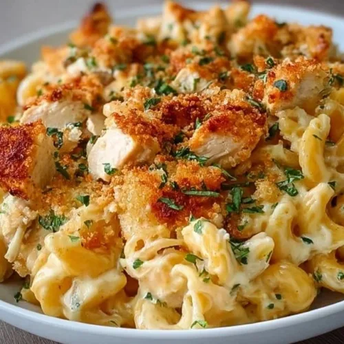 Easy and delicious cheesy chicken pasta bake with melted cheese and chicken