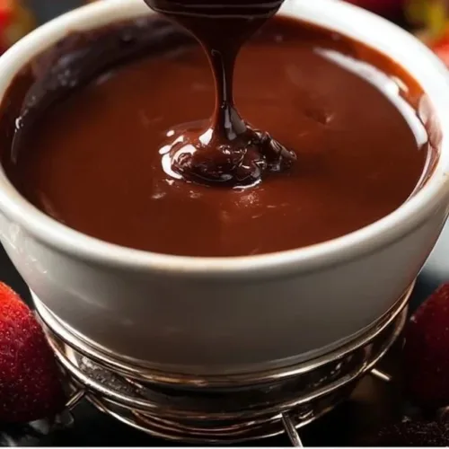Bowl of easy chocolate fondue with strawberries and marshmallows for dipping