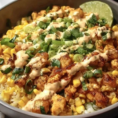 Easy street corn chicken rice bowls with vibrant toppings in a bowl