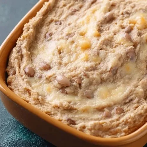 High protein bean dip served with tort chips and fresh veggies
