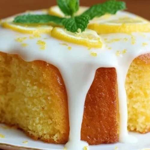 Homemade lemon cake topped with fresh lemon slices and icing