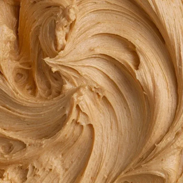 Delicious homemade peanut butter icing drizzled over cupcakes