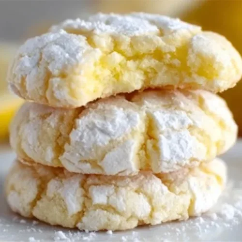 Freshly baked Lemon Crinkle Cookies dusted with powdered sugar