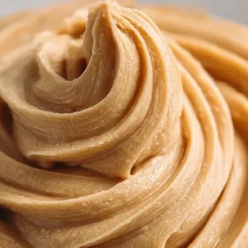 Delicious quick and easy peanut butter frosting spread on cake
