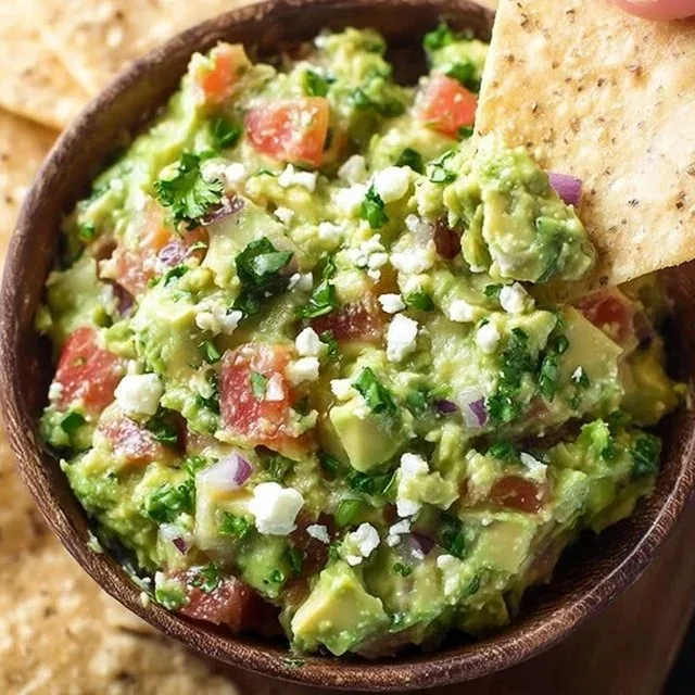 Creamy and delicious avocado feta dip served in a bowl with tortilla chips