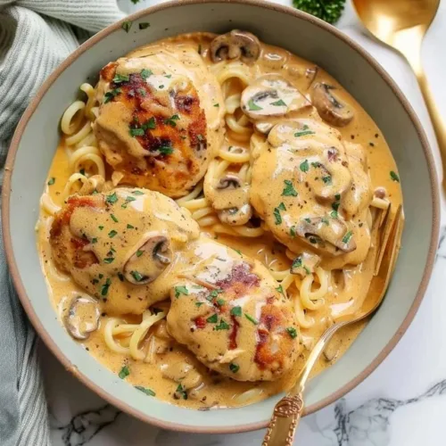 Delicious Easy Crockpot Marry Me Chicken served in a bowl with herbs.