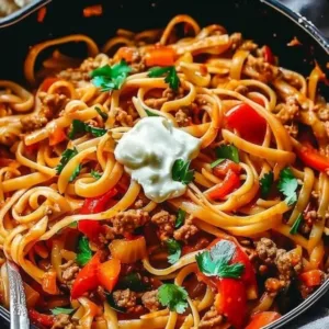 One pot chicken fajita pasta in a skillet with colorful bell peppers and chicken.