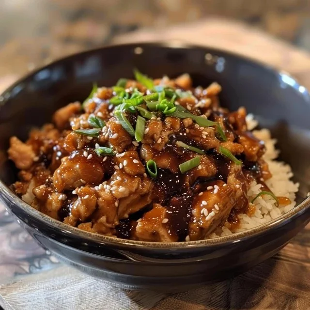 Crockpot Honey Garlic Chicken served in a bowl with rice and vegetables