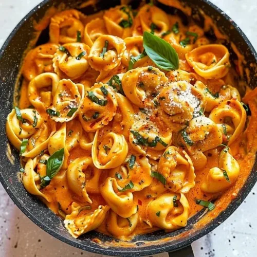 Spicy Garlic Butter Chicken Tortellini with herbs and spices garnished