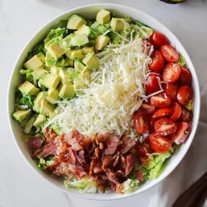 Delicious BLT salad topped with creamy ranch dressing and fresh ingredients.