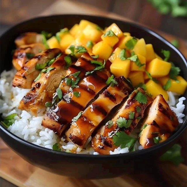 Easy Asian Mango Glazed Chicken garnished with green onions and sesame seeds.