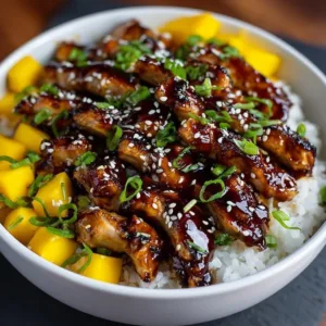 Delicious Mango Glazed Chicken garnished with fresh mango slices and herbs