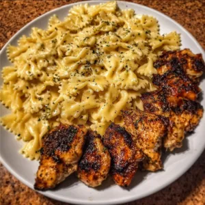 Plate of Garlic Butter Chicken Bowtie Pasta with herbs and cheese