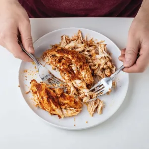 Delicious Mexican pulled chicken served in a taco with fresh toppings