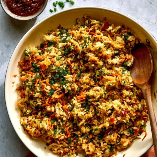 Thai Chicken Cabbage Skillet served in a pan garnished with fresh herbs.