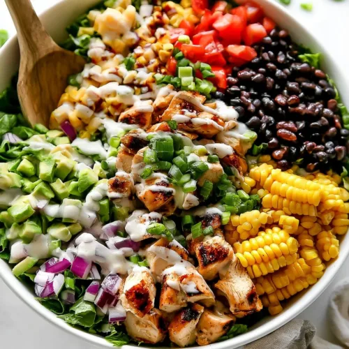 A vibrant dish of creamy BBQ chicken salad with vegetables and dressing