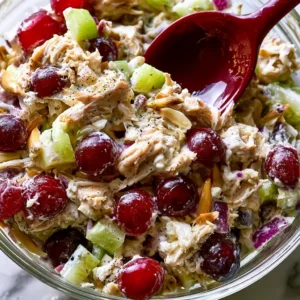 Delicious homemade chicken salad served in a bowl with fresh ingredients.