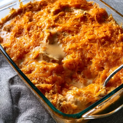 Cheesy Buffalo Chicken Dip served with tortilla chips on a wooden table
