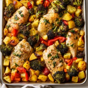 Easy garlic butter chicken sheet pan dinner with vegetables and herbs