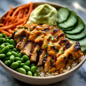 Delicious Thai Peanut Chicken Bowl topped with fresh vegetables and peanuts.